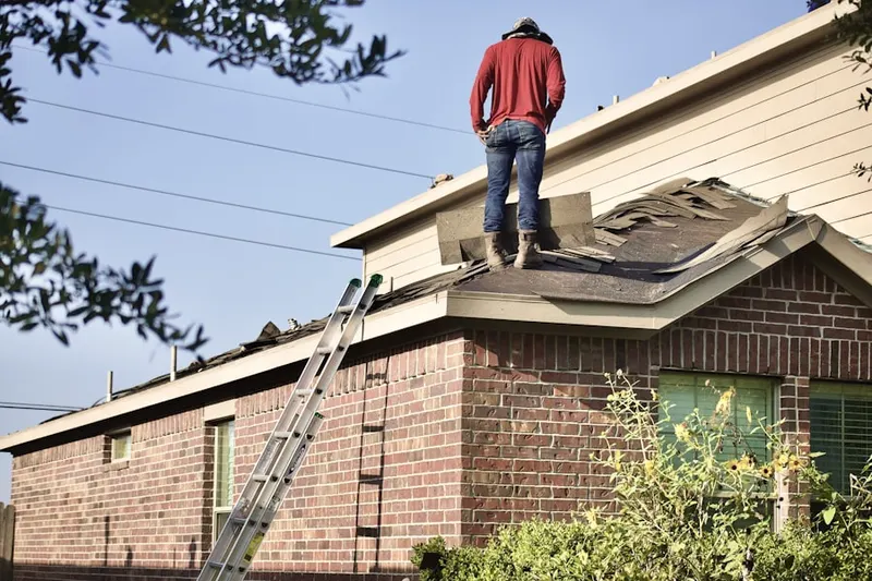 Professional roofer working on a residential roof in Bismarck
